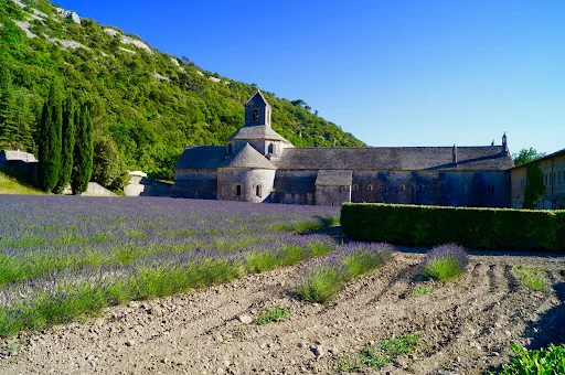 Grey church building in foot of hill