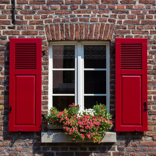 Old German house with white windows and flower pots, Wachtendonk, North-Rhine Westphalia, Germany