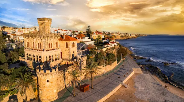 Aerial Drone view of Tamariz Beach and Forte da Cruz Castle in Estoril at Sunset Portuguese Riviera Coastal Landscape