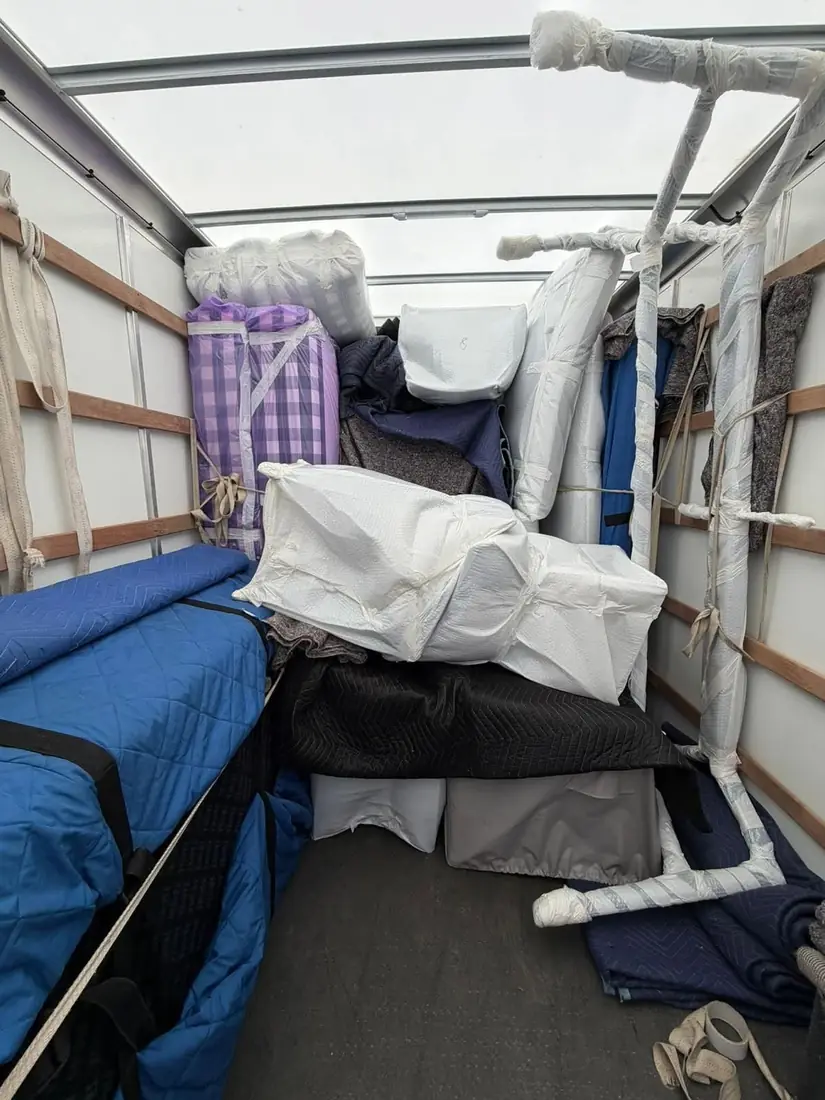 Furniture export wrapped and blanketed inside a Gentlevan vehicle loaded for a European move