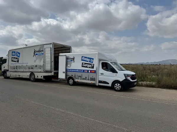 Gentlevan Removals European removals vehicles parked roadside in the Netherlands during an international house move, with a Luton van transferring items into a larger removals lorry.