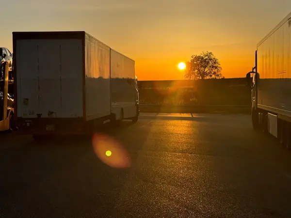 Gentlevan removals lorry parked at a European truck stop at sunrise on a run to Spain