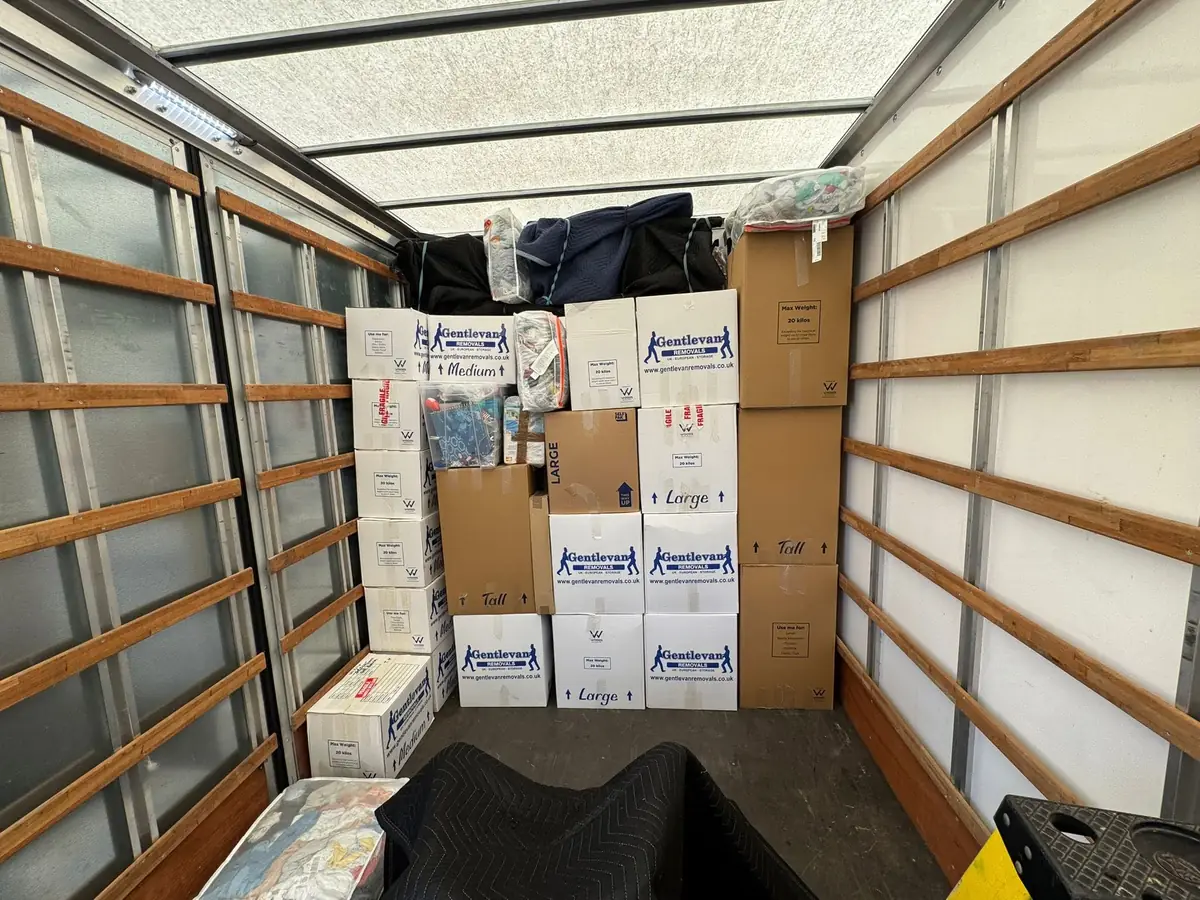 Branded Gentlevan Removals cartons and blanket wrapped items stacked and secured inside the vehicle