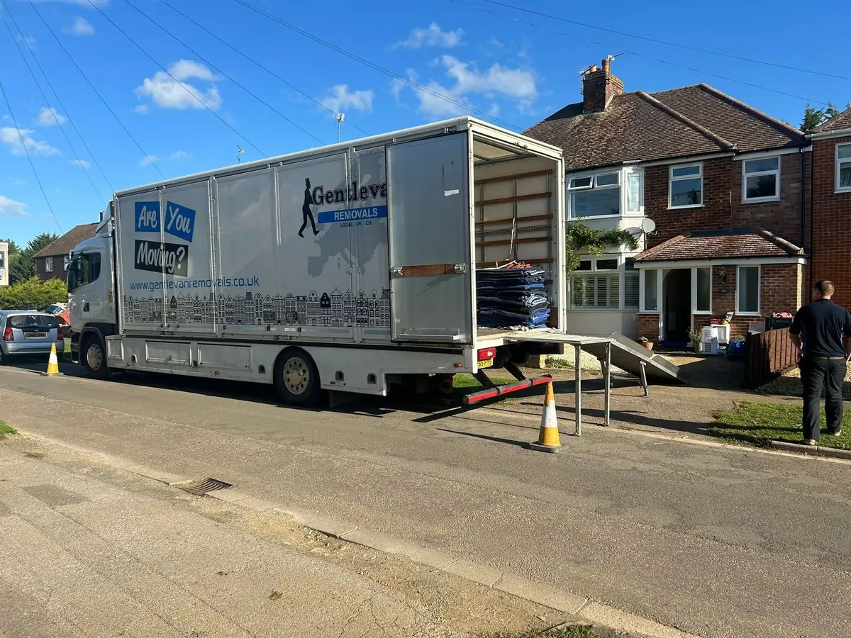 Gentlevan Removals lorry with the tail lift and loading ramp down outside a house at the UK end of a European move