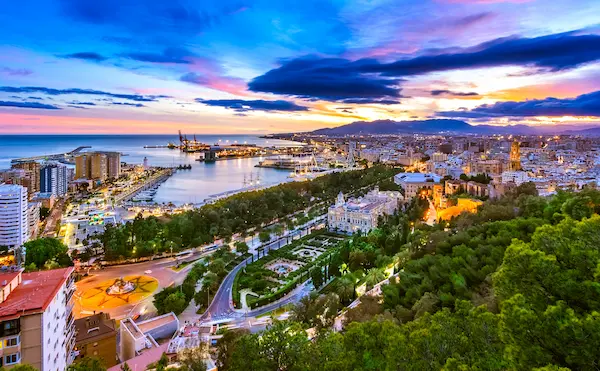 Málaga port and city skyline at dusk seen from Gibralfaro, Costa del Sol — UK to Málaga removals by Gentlevan