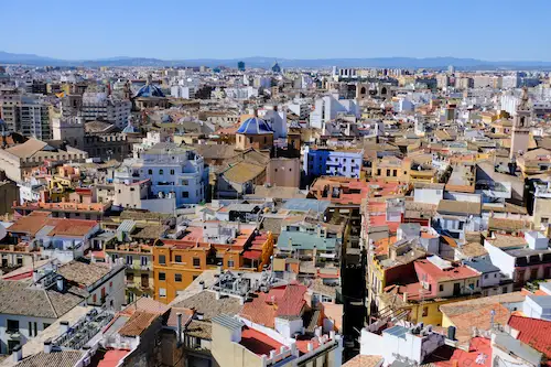 A view across the rooftops of the Old Town of Valencia in Spain, showing the historic and crowded architecture and street views