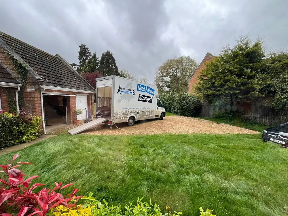 A Gentlevan Luton van with its loading ramp down on a gravel driveway at a UK collection